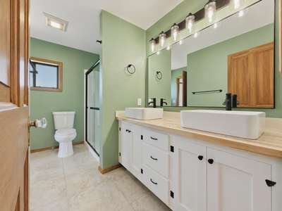 Finished bathroom with new vanity, vessel sink and tile floor